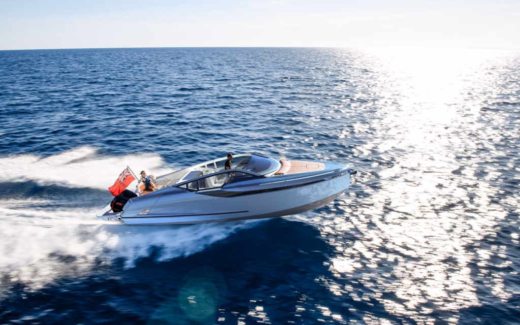 Luxury yacht speeds across ocean.