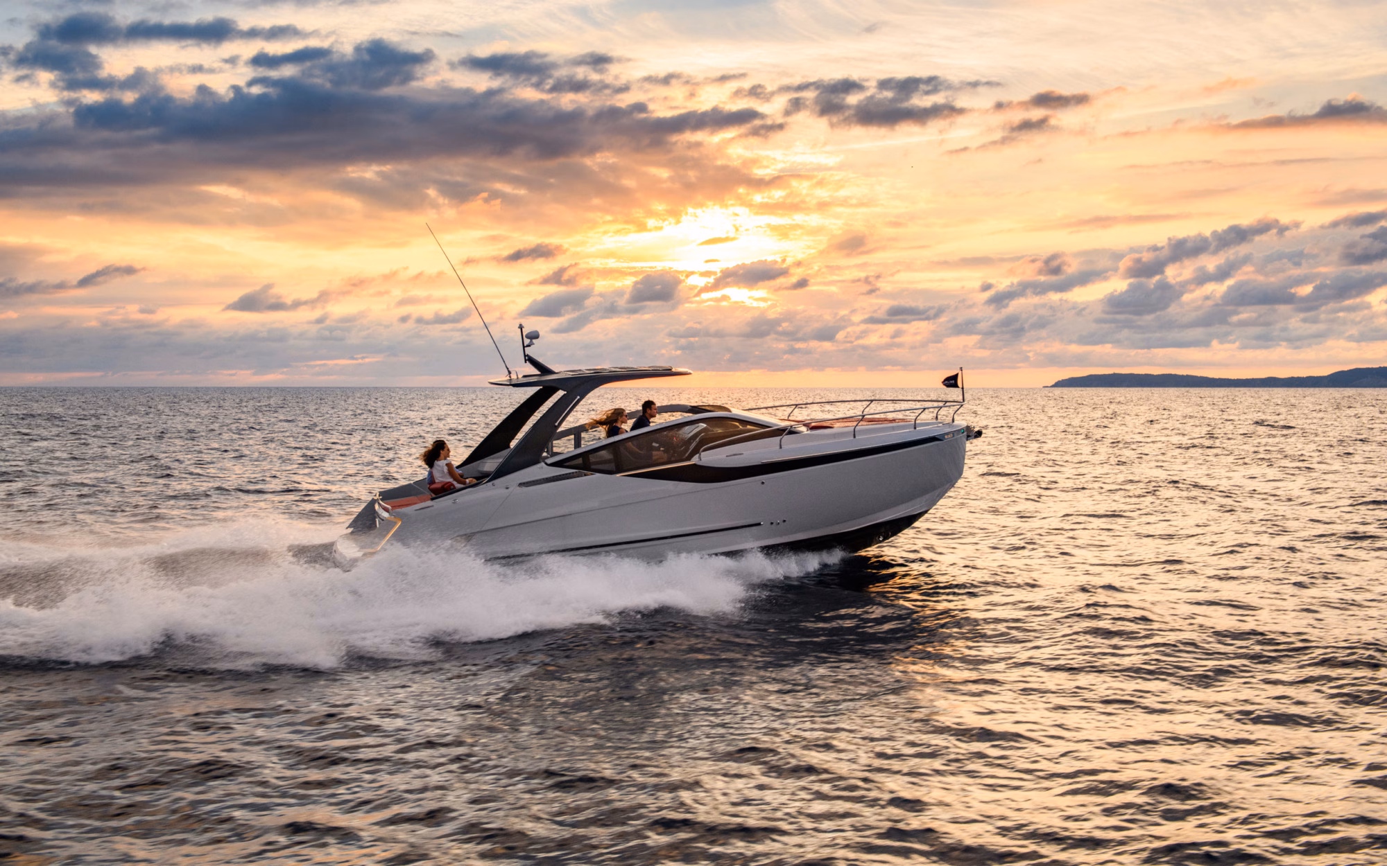 Boat sailing at sunset