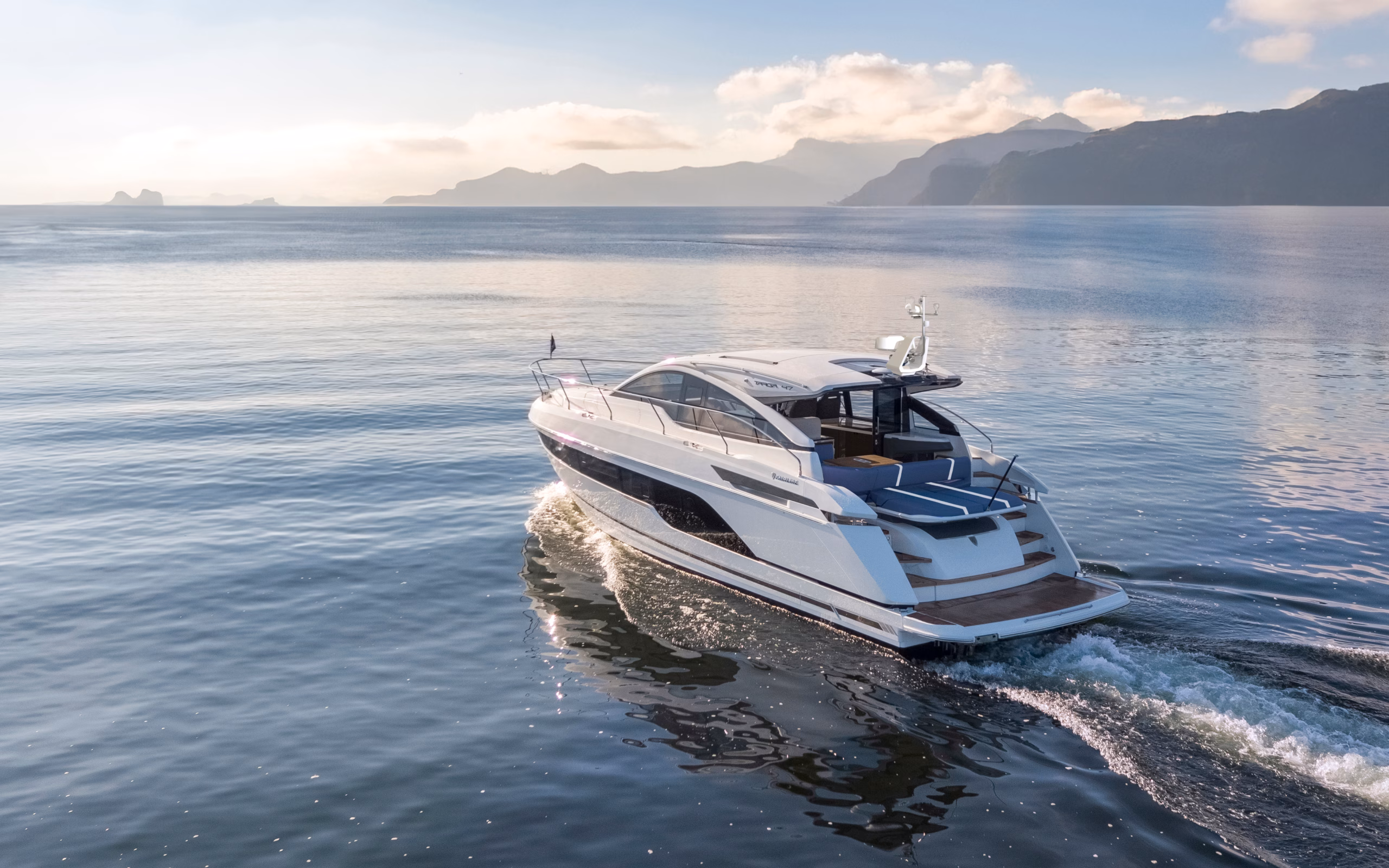 White yacht sailing on water